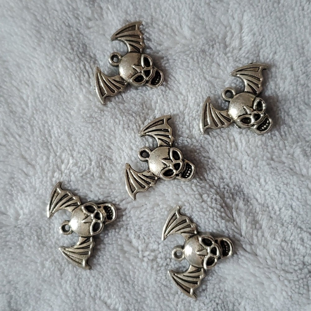 Five skull bat wings pendents for jewelry making.